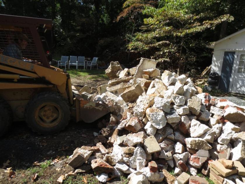 Tons of rubble at the back of our driveway divided the cottage from the house.