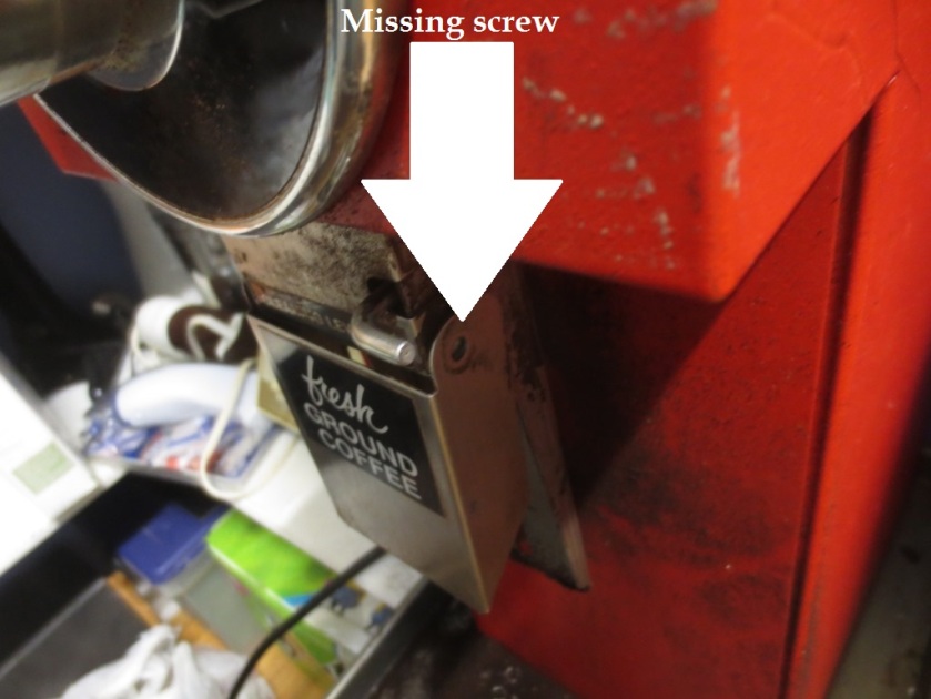 The screw on one side of the grinder's cleaning chute was missing.